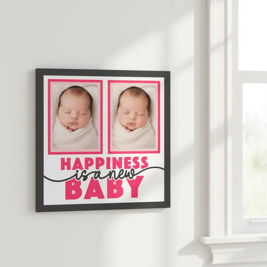 Framed picture with text 'Happiness is a new baby' on a white background