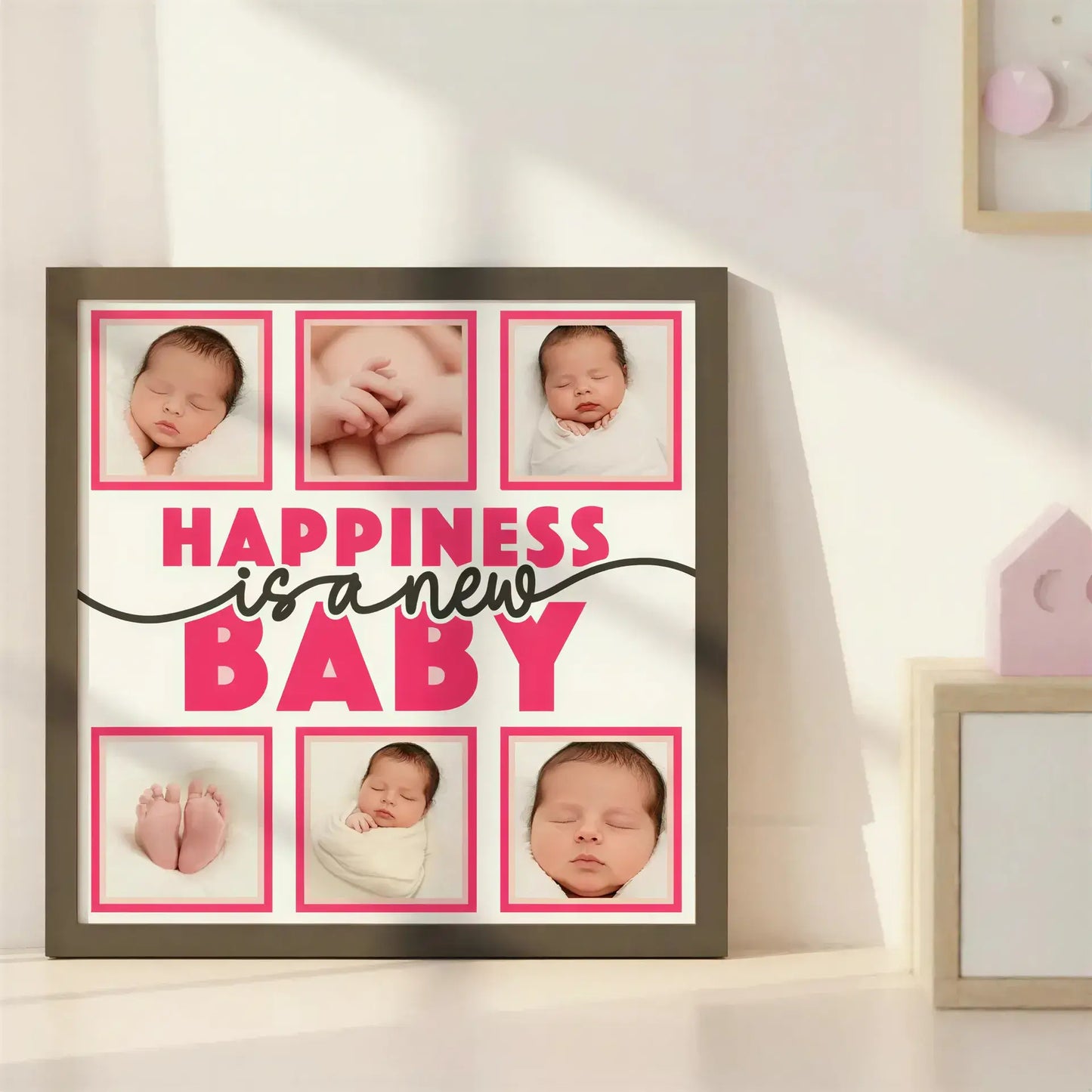 Decorative sign with 'Happiness is a new baby' text and blank spaces for photos.