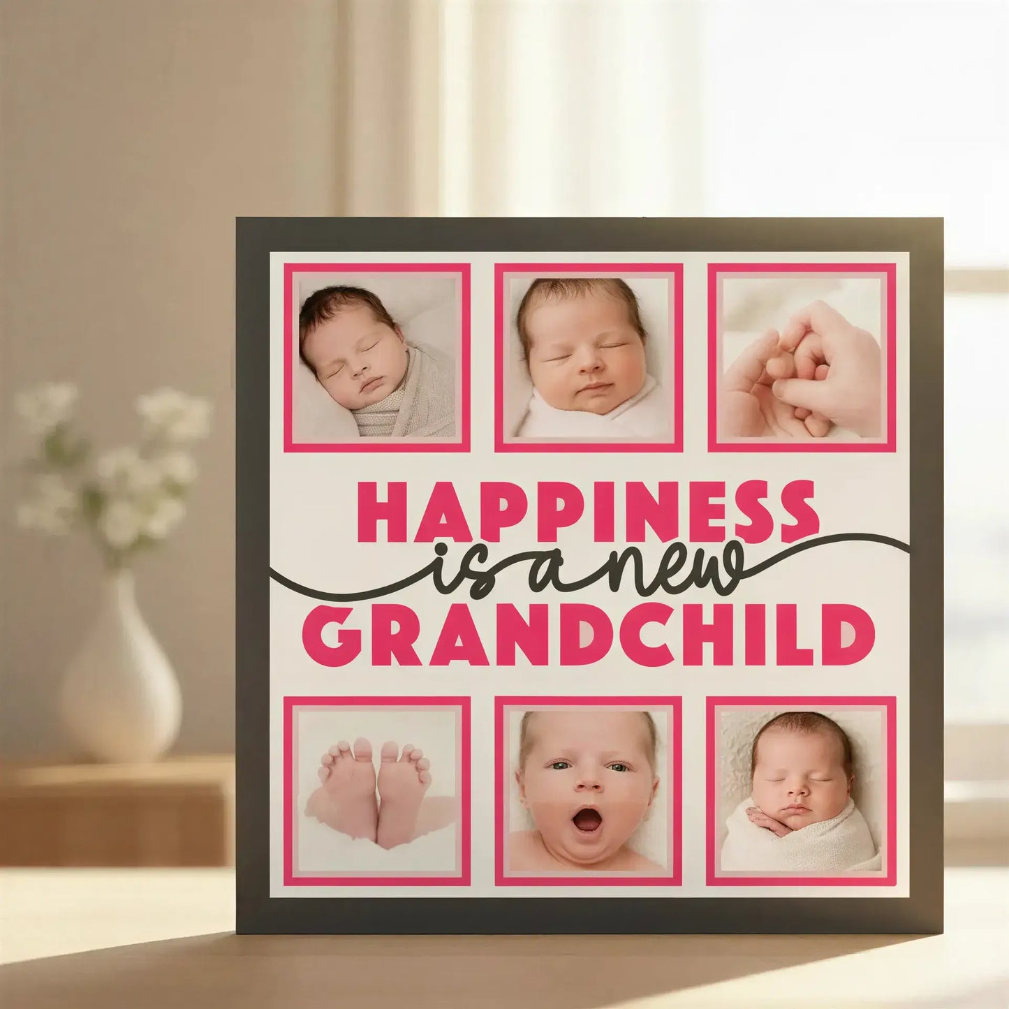 Decorative sign with 'Happiness is a new grandchild' text and six blank photo frames.