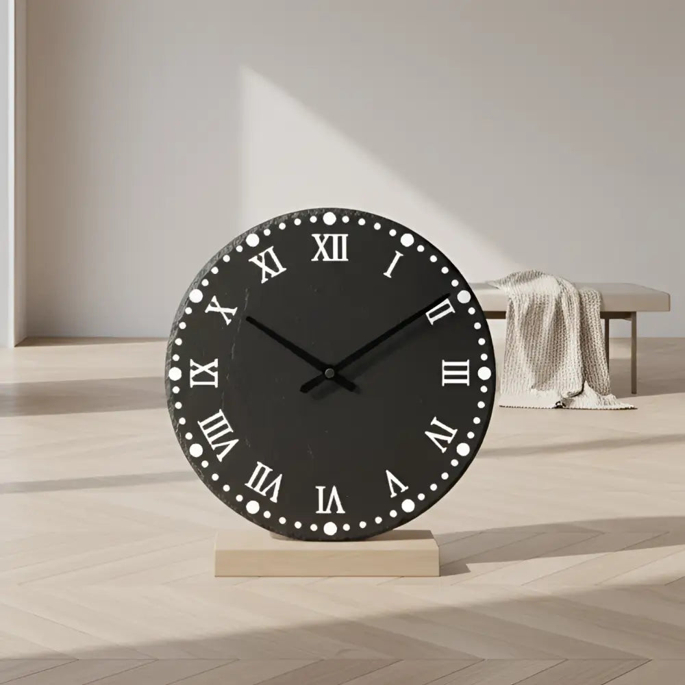 Round slate clock face with Roman numerals on a slate background