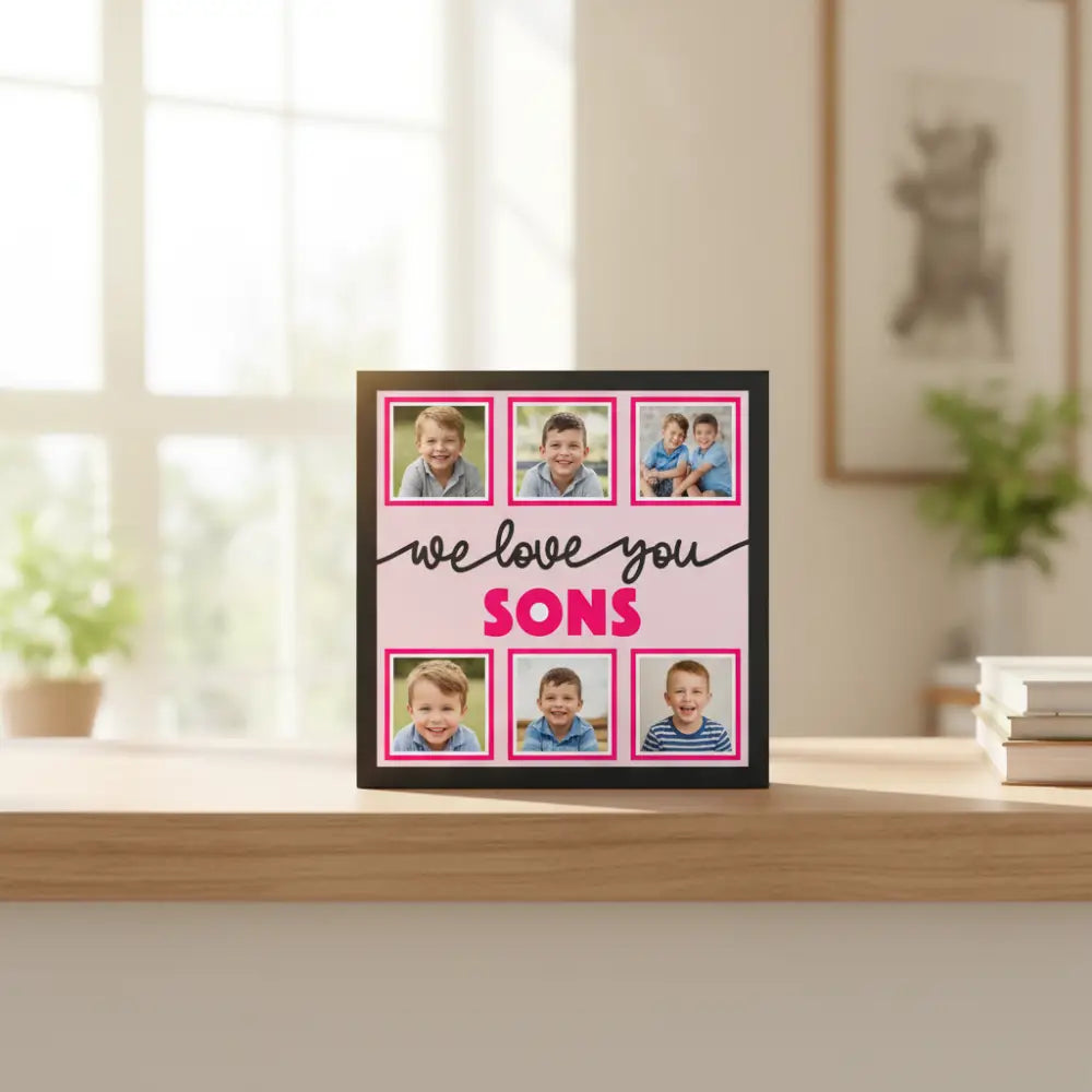 Decorative sign with 'we love you SONS' text and photo frames on a pink background