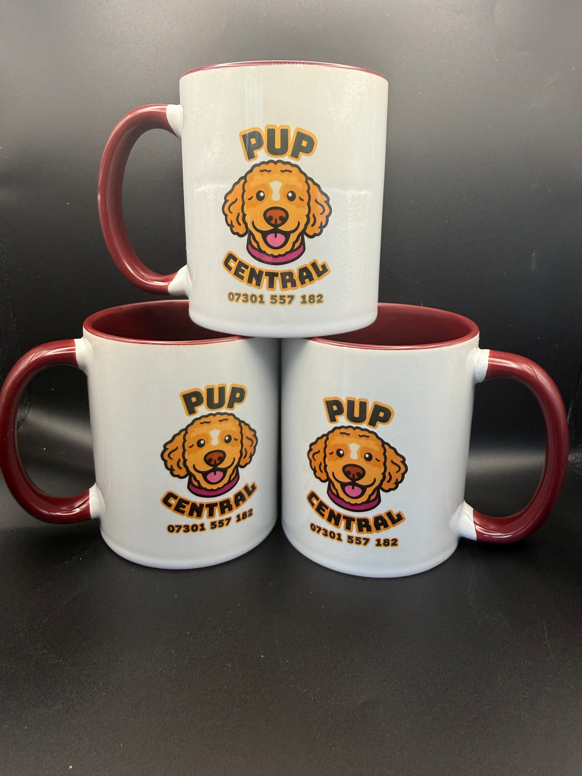 Personalised mugs with a dog business logo and maroon handles