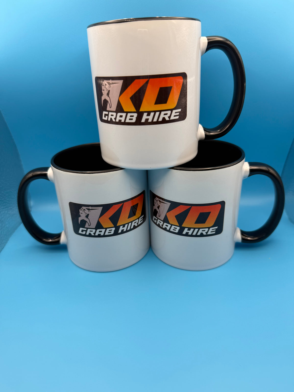 Personalised mugs with a business logo and black handles