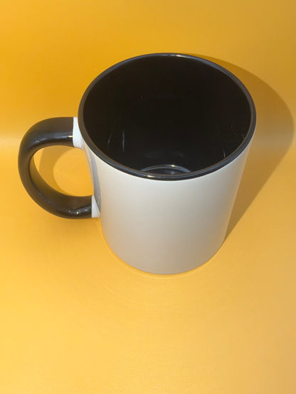 Black mug showing its coloured interior and handle