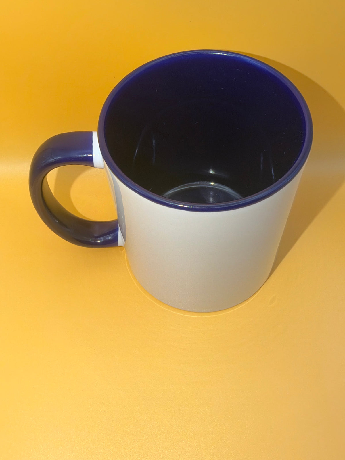 Dark blue mug showing its coloured interior and handle