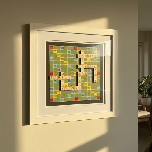 Framed artwork with Scrabble tile letters on a grid