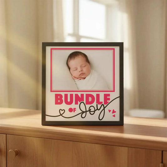 Framed print with 'Bundle of Joy' text and decorative hearts on a white background