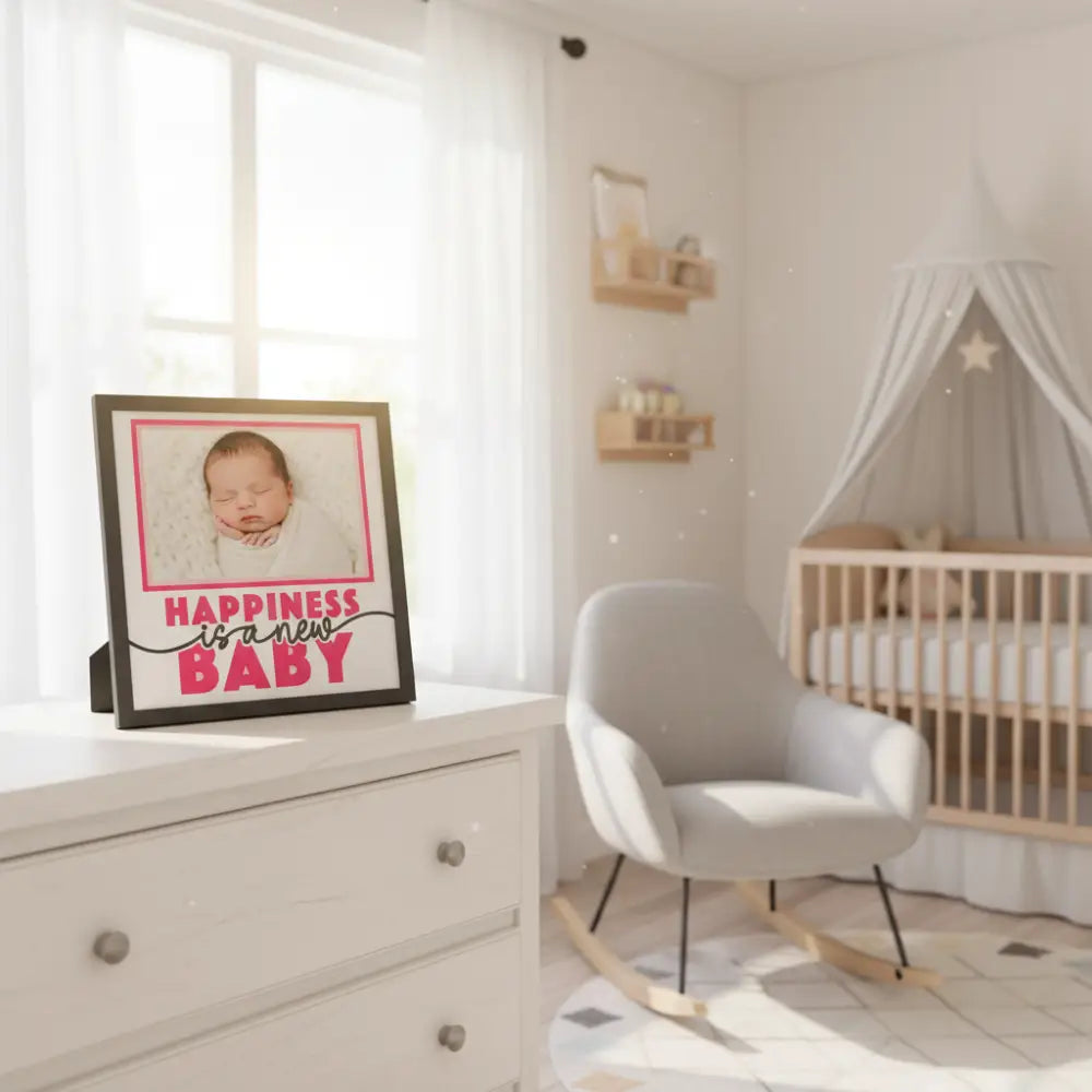 Framed quote 'Happiness is a new baby' with pink text on a white background