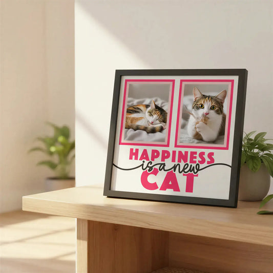 Framed quote print with 'Happiness is a new cat' text on a white background