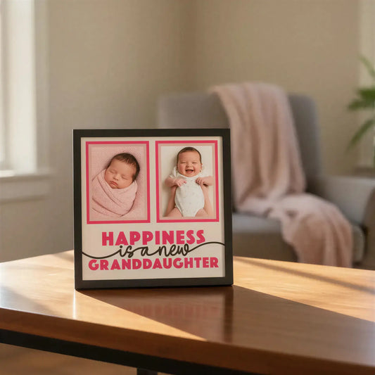 Framed print with 'Happiness is a new granddaughter' text and two blank photo frames.
