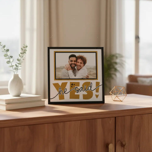 Decorative sign with 'he said yes!' text on a white background