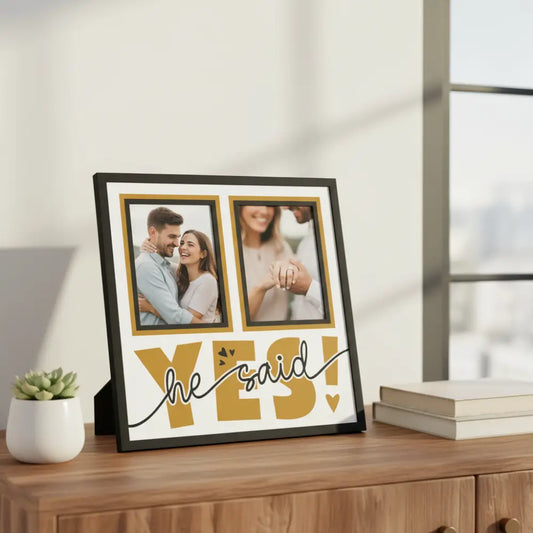Decorative sign with 'he said yes!' text and two blank frames on a white background