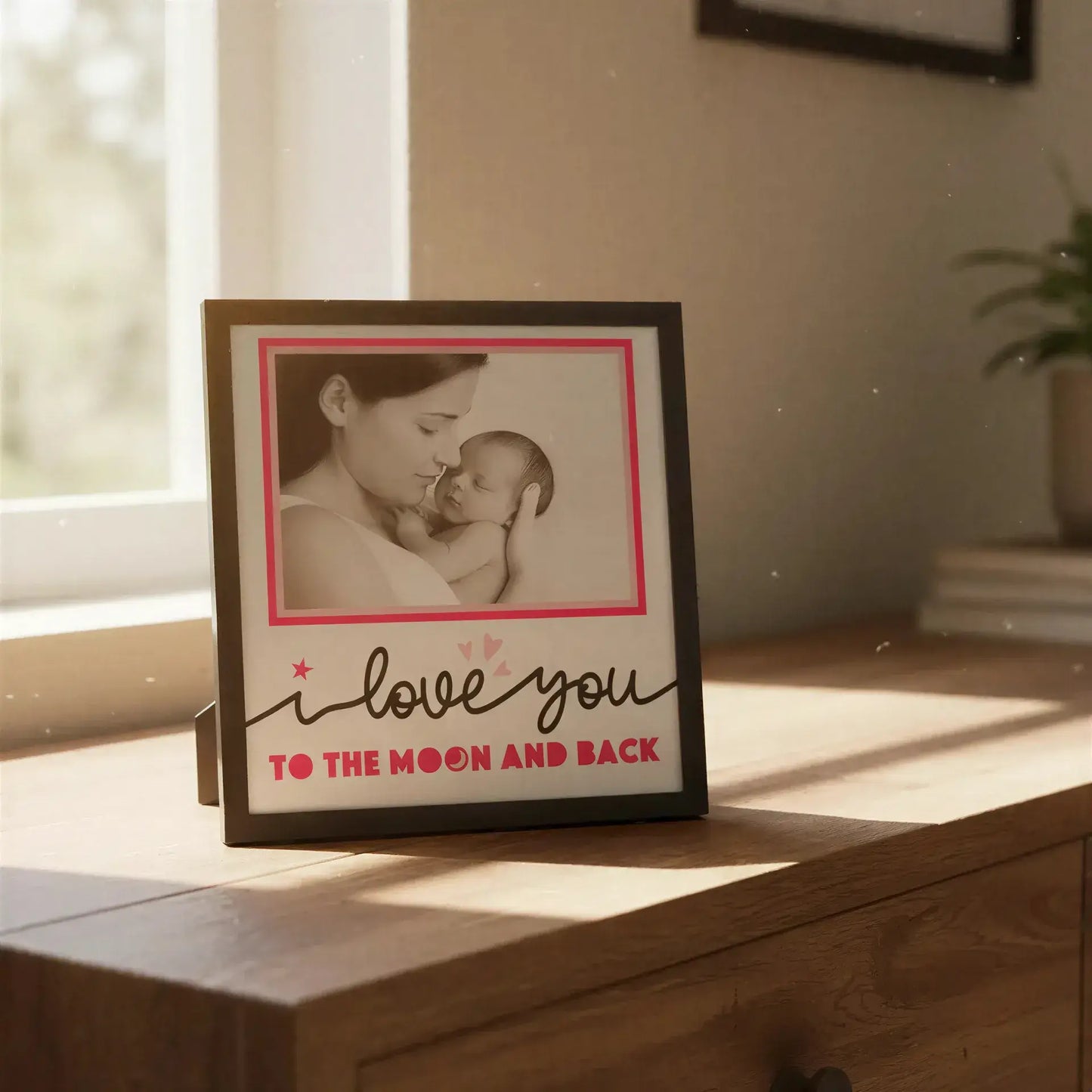 Decorative frame with 'I love you to the moon and back' text and pink border.