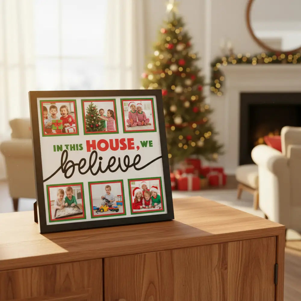 Decorative sign with text 'In this house, we believe' surrounded by red and green borders.