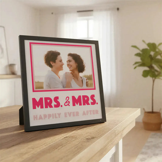 Decorative sign with 'MRS. & MRS. HAPPILY EVER AFTER' text on a white background.