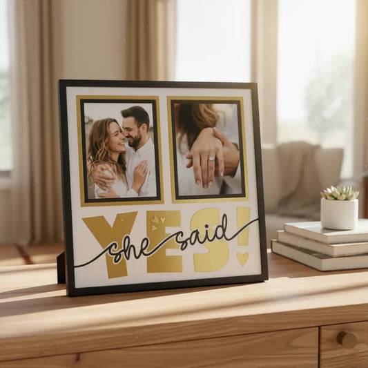 Decorative sign with 'YES! she said' text and two empty frames on a white background.