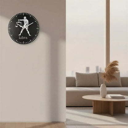 Zodiac sign of Libra with a person holding scales on a black slate background