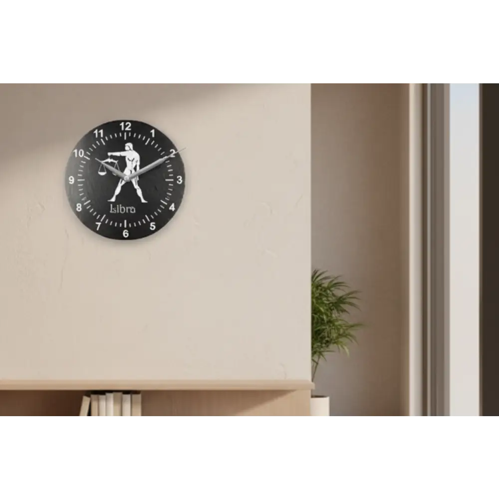 Decorative slate clock face with Libra zodiac symbol on a black background