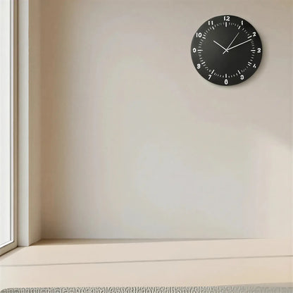 Black slate clock face with white numbers on a gray background