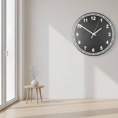 Circular slate clock face with numbers on a metallic background