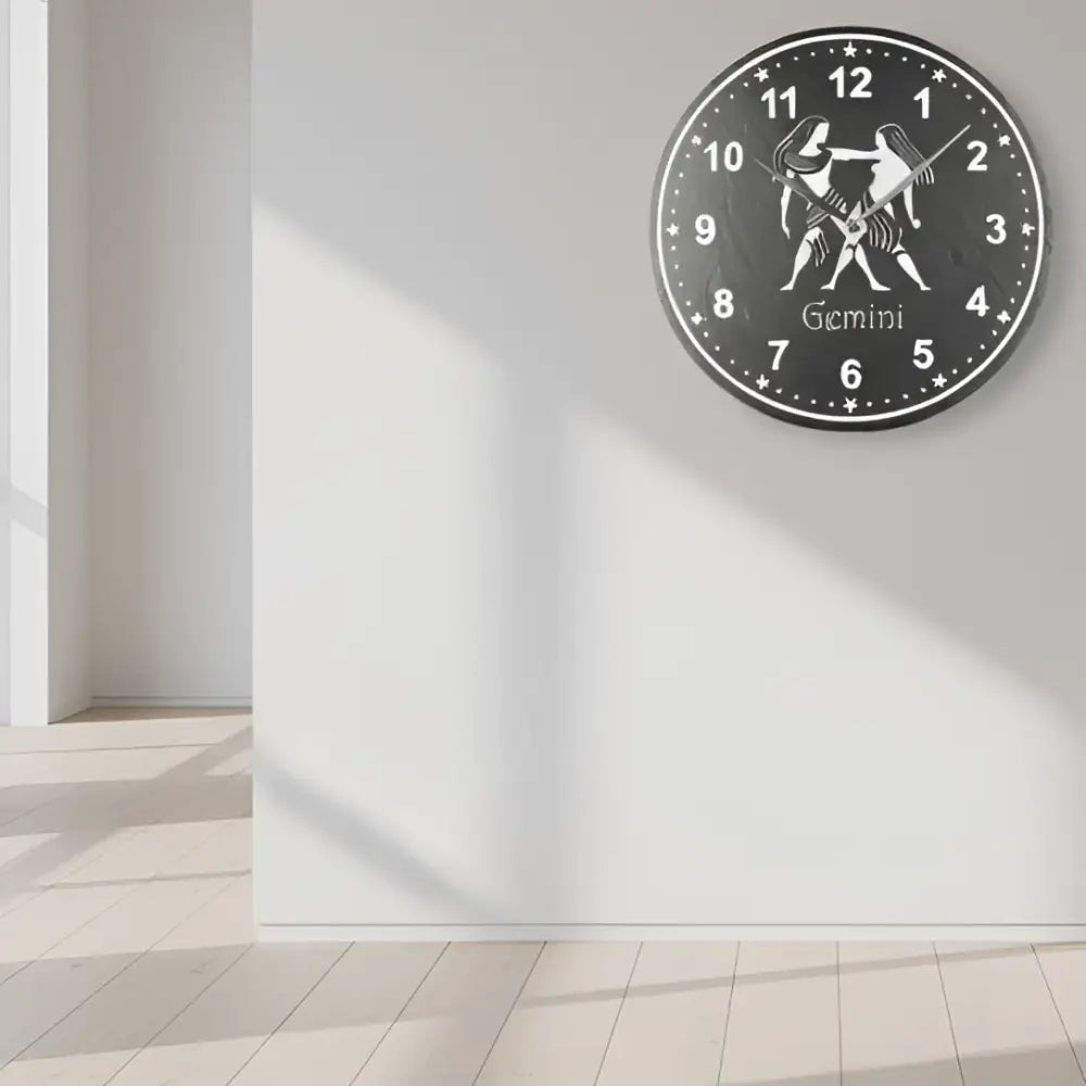 Slate clock with Gemini zodiac sign design on a black background