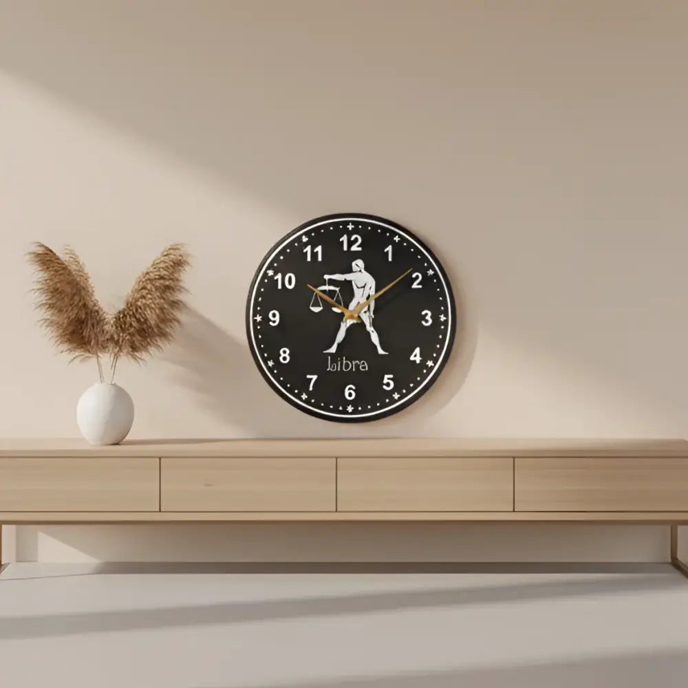 Decorative slate clock with Libra zodiac sign on a black background
