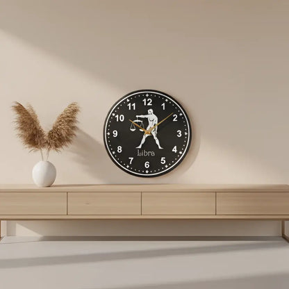 Decorative slate clock with Libra zodiac sign on a black background