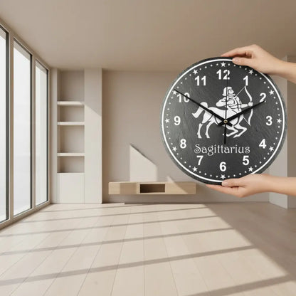 Sagittarius zodiac sign on a slate clock face with numbers and stars.
