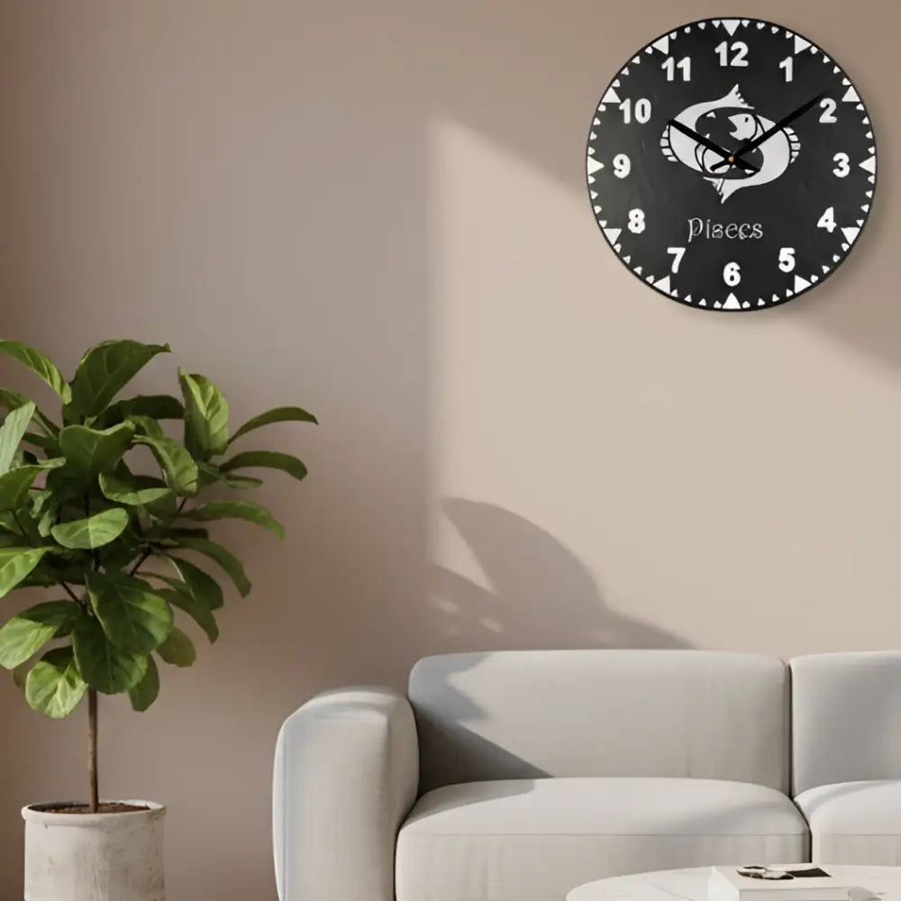 Slate clock face with Pisces zodiac symbol and numbers on a black background