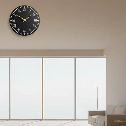 Round slate clock face with Roman numerals on a white background