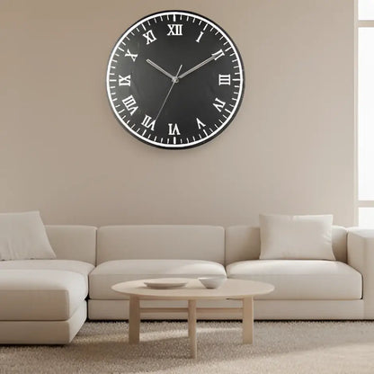 Round slate clock face with Roman numerals on a black background