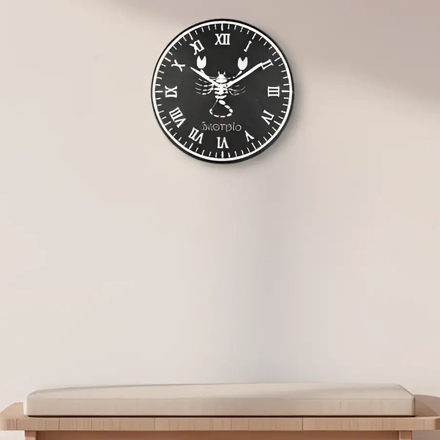 Decorative slate wall clock with Scorpio zodiac symbol and Roman numerals on a black background