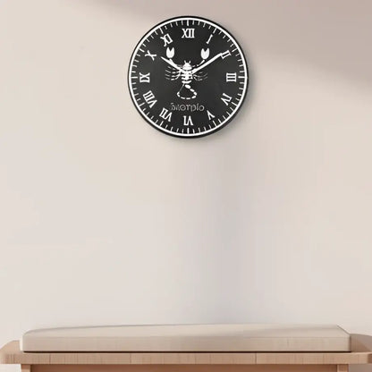 Decorative slate wall clock with Scorpio zodiac symbol and Roman numerals on a black background