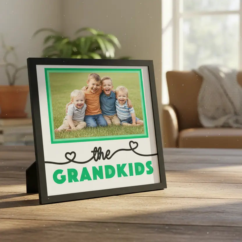 Decorative sign with 'the GRANDKIDS' text and green hearts on a white background