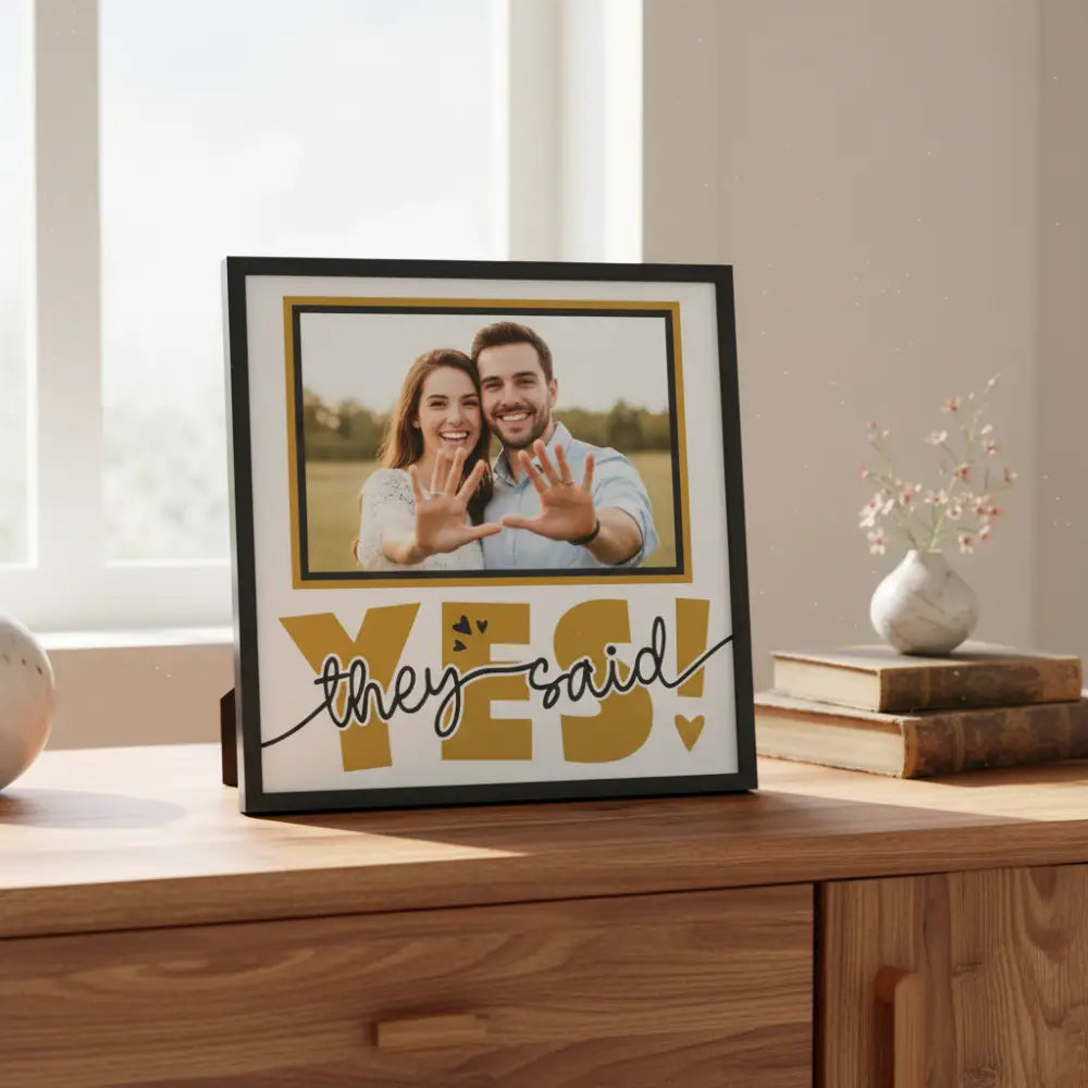 Decorative sign with 'YES! they said' text in gold and black on a white background