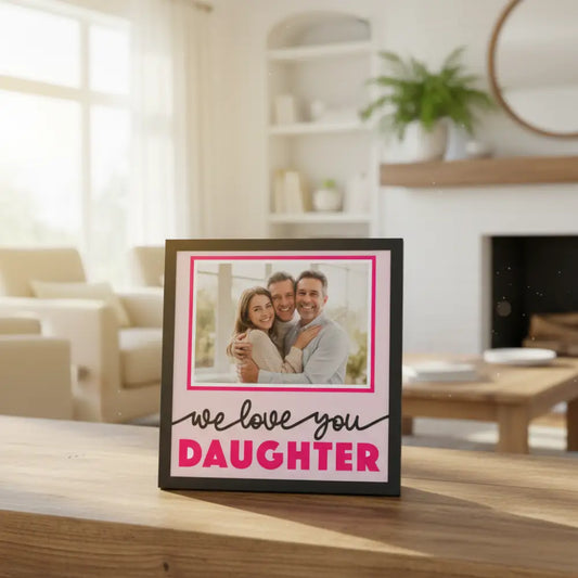 Framed print with 'we love you DAUGHTER' text on a pink background
