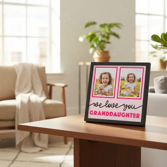 Decorative wall art with two photo frames and text 'we love you granddaughter' on a pink background.