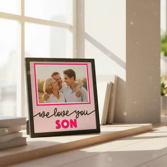 Decorative sign with 'we love you son' text on a pink background