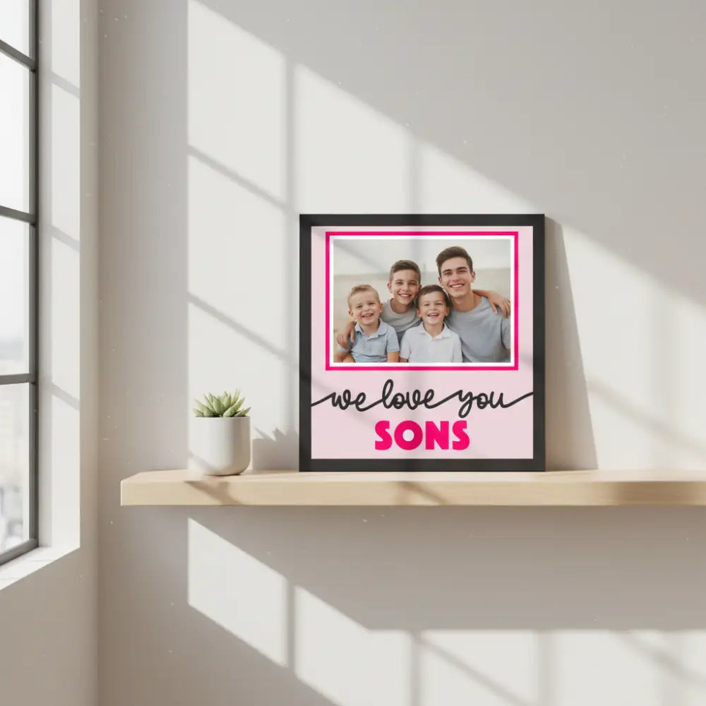 Decorative sign with 'we love you SONS' text on a pink background